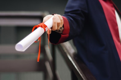 person holding white scroll