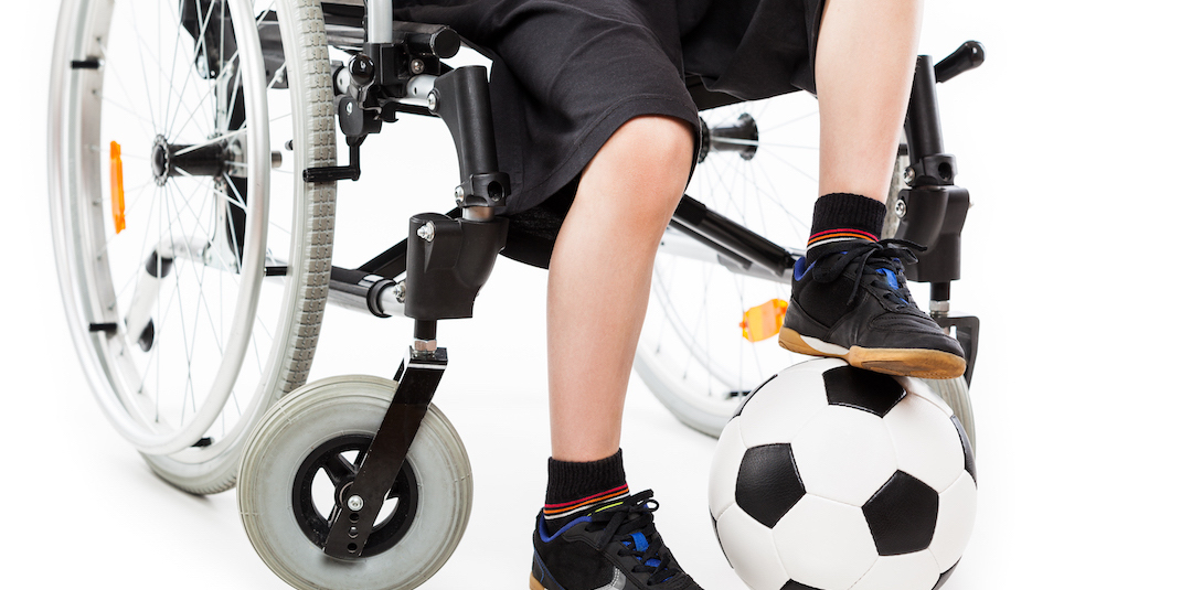 Child in a wheelchair with a soccer ball