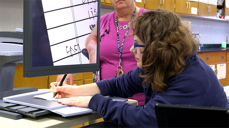 A young woman using assistive technology